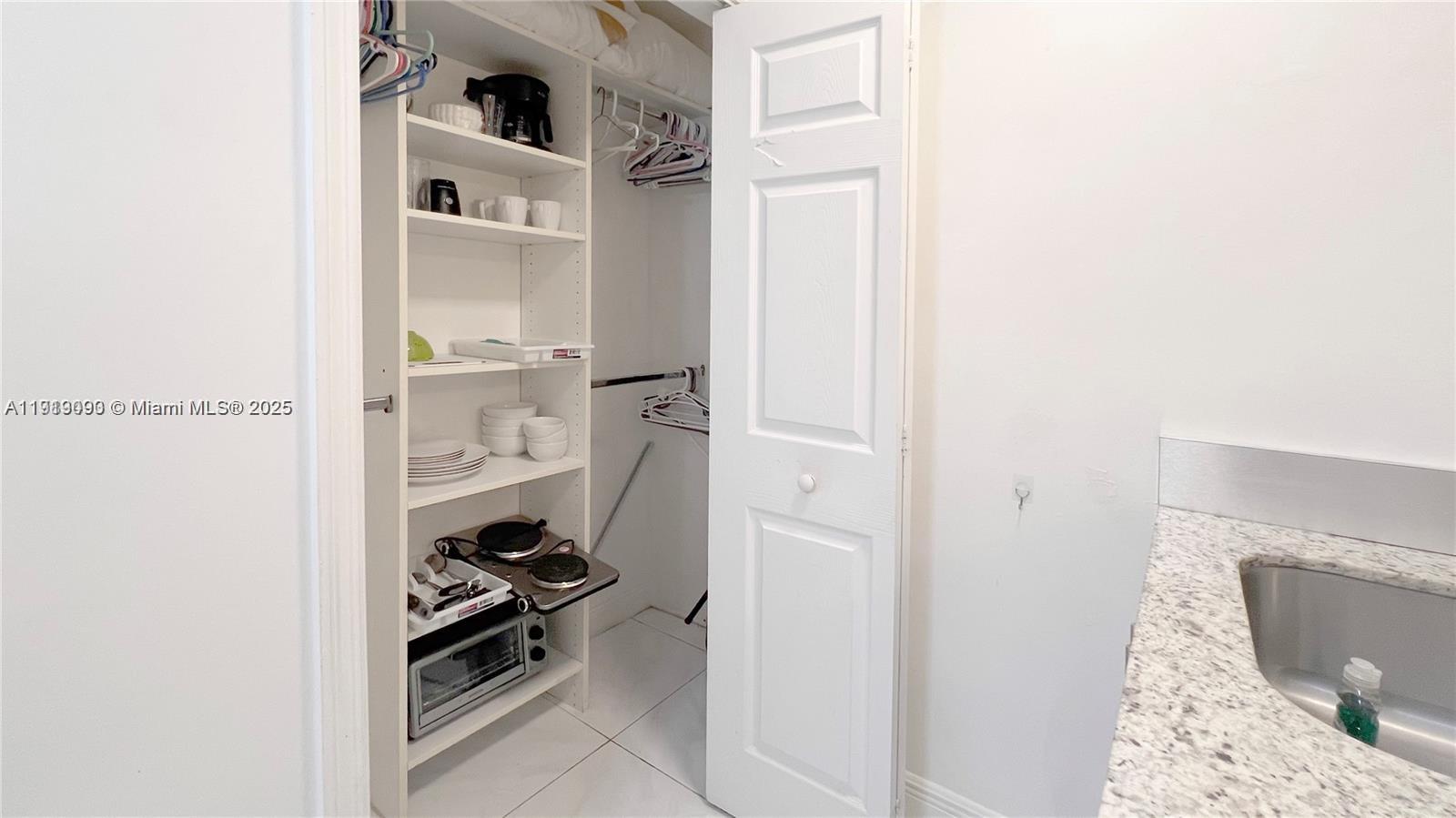 1950 Southwest 5th Street, Unit 2 Miami, FL 33135 - Photo 10 of 11 a view of walk in closet with clothes and shoes