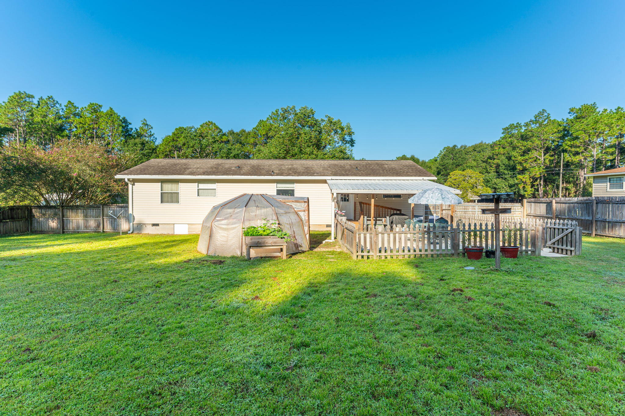 671 Ridge Lake Road Crestview, FL 32536 - Photo 6 of 26 Back Patio with Greenhouse