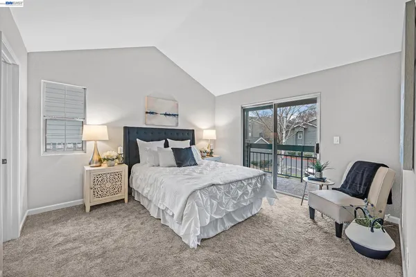 a bedroom with a bed and a chair