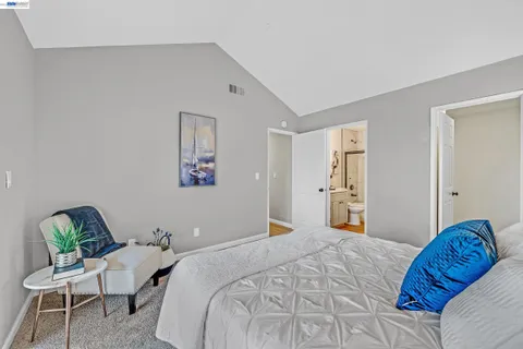 a bedroom with a bed and chair