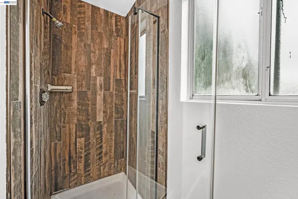an empty room with windows and closet