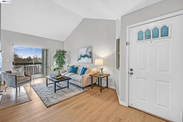 a living room with furniture rug and window