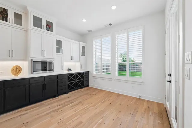 a large kitchen with stainless steel appliances granite countertop a sink and dishwasher with wooden floor