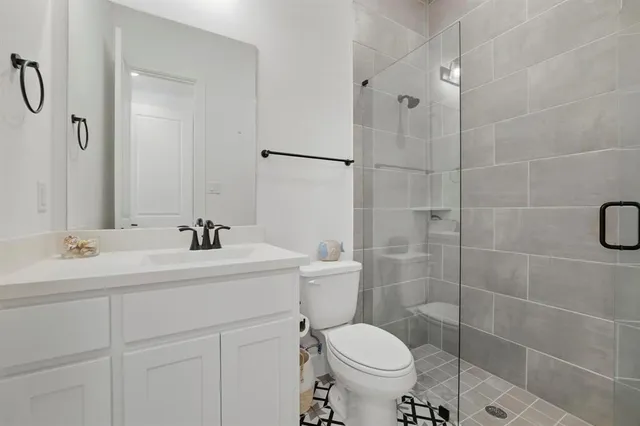 a bathroom with a sink toilet and shower