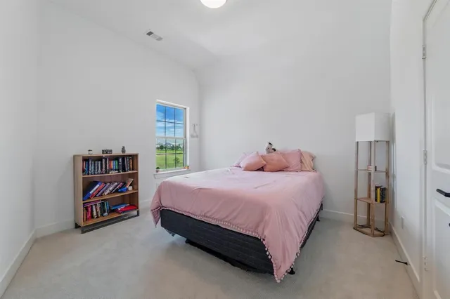 a bedroom with a bed and a book shelf