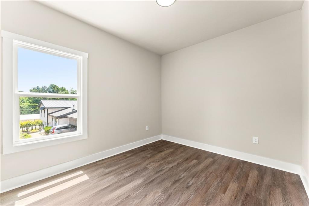 43 Anderson Street Jefferson, GA 30549 - Photo 26 of 45 a view of a small space with wooden floor and a window