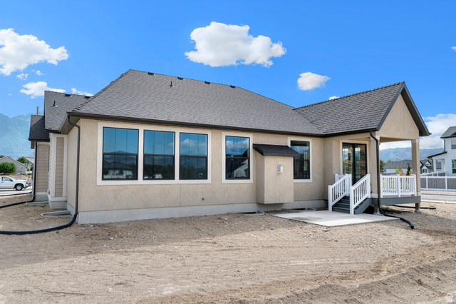 11718 South Halls Crk Road Draper, UT 84020 - Photo 4 of 28 Back of property featuring roof with shingles, stucco siding, and a patio area