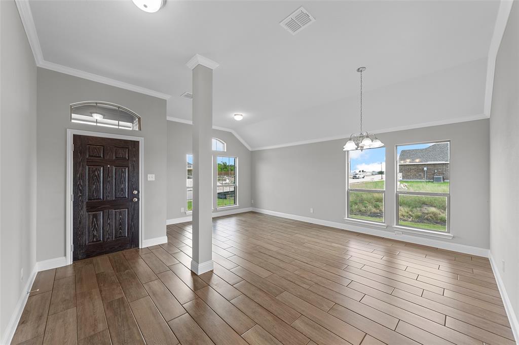 312 Pennington Road Josephine, TX 75173 - Photo 4 of 22 a view of an empty room with window and wooden floor
