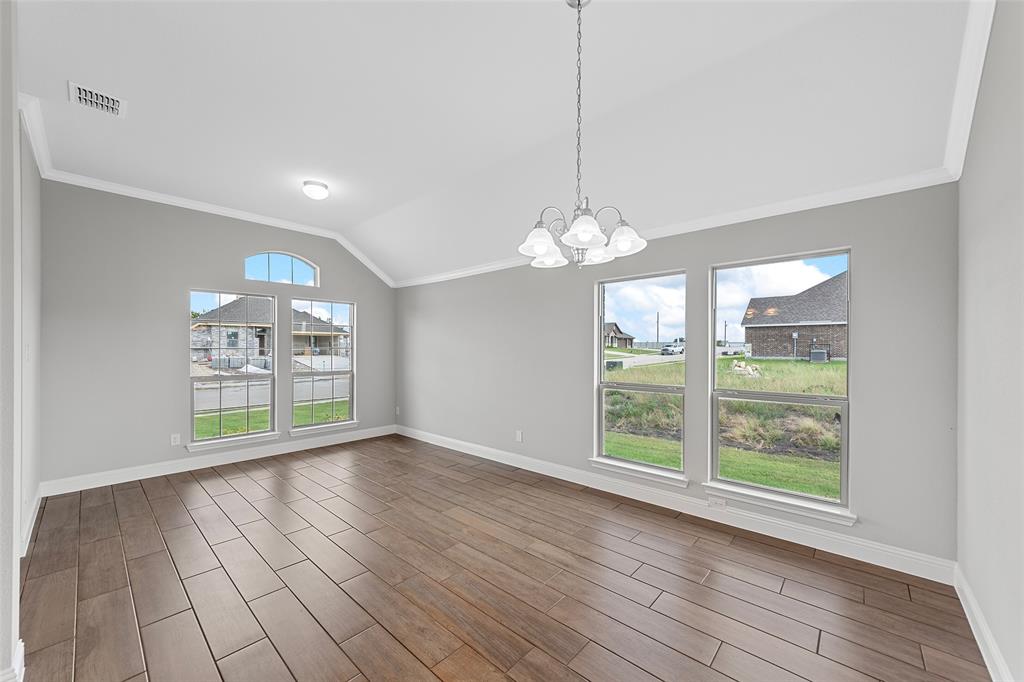 312 Pennington Road Josephine, TX 75173 - Photo 5 of 22 a view of an empty room with wooden floor and a window