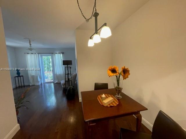2870 Pine Tree Drive, Unit 2 Miami Beach, FL 33140 - Photo 14 of 36 a view of a dining room with furniture and wooden floor