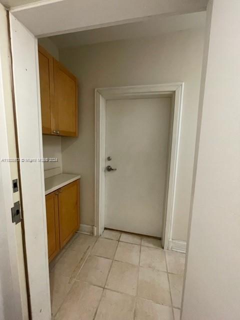 2870 Pine Tree Drive, Unit 2 Miami Beach, FL 33140 - Photo 34 of 36 a bathroom with a granite countertop sink a toilet and a mirror