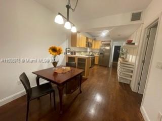 2870 Pine Tree Drive, Unit 2 Miami Beach, FL 33140 - Photo 10 of 36 a view of a dining room with furniture and wooden floor