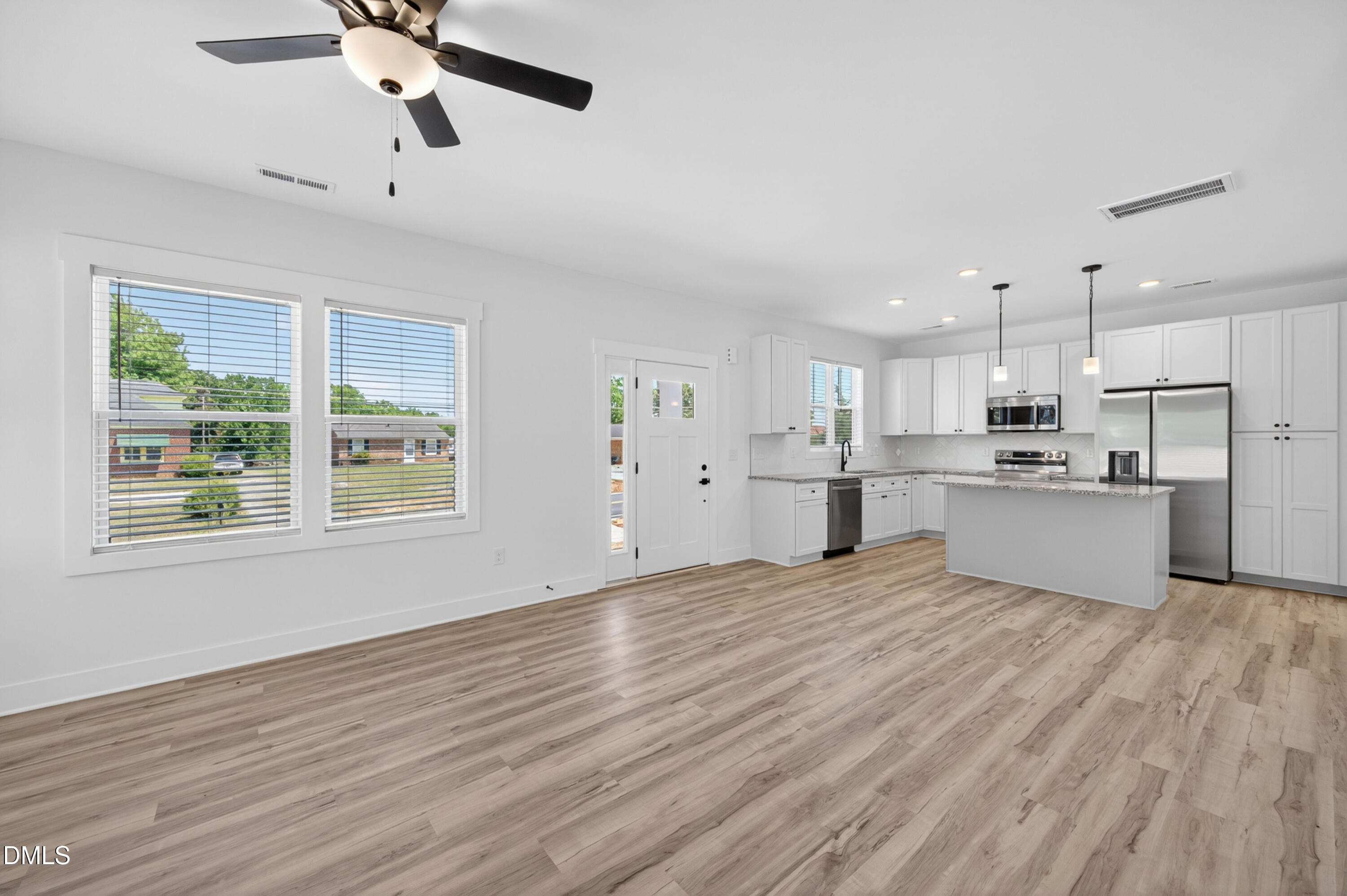 1182 Hurdle Mills Road Roxboro, NC 27573 - Photo 17 of 45 a view of kitchen with wooden floor and window