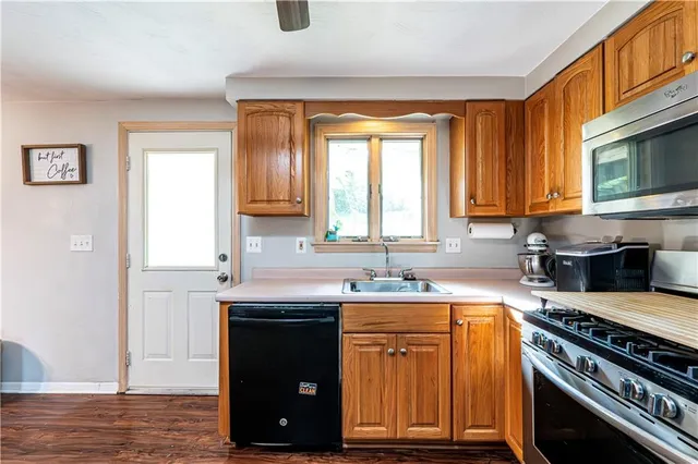 a kitchen with a stove a sink and a microwave