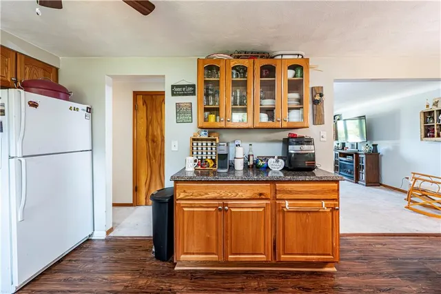 a kitchen with stainless steel appliances granite countertop a refrigerator and a stove top oven
