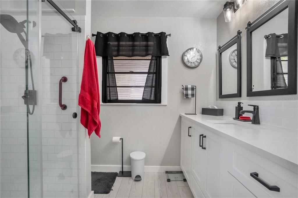 8431 Delaware Drive Weeki Wachee, FL 34607 - Photo 25 of 64 a bathroom with a sink and a mirror