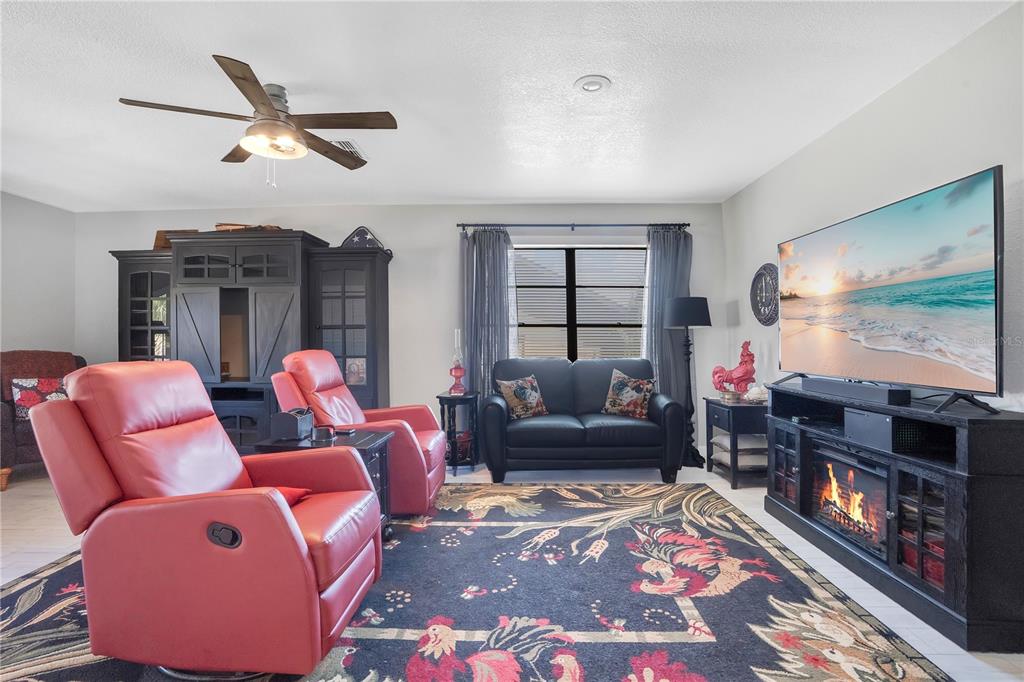 8431 Delaware Drive Weeki Wachee, FL 34607 - Photo 29 of 64 a living room with furniture and a flat screen tv
