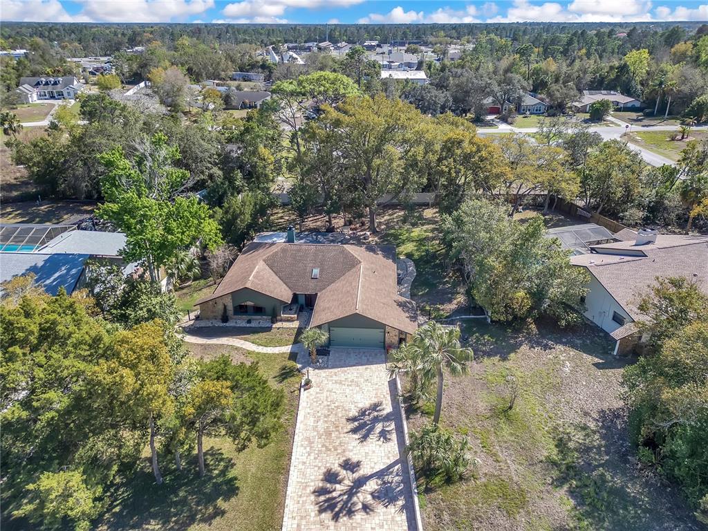 8431 Delaware Drive Weeki Wachee, FL 34607 - Photo 3 of 64 an aerial view of house with yard and mountain view in back