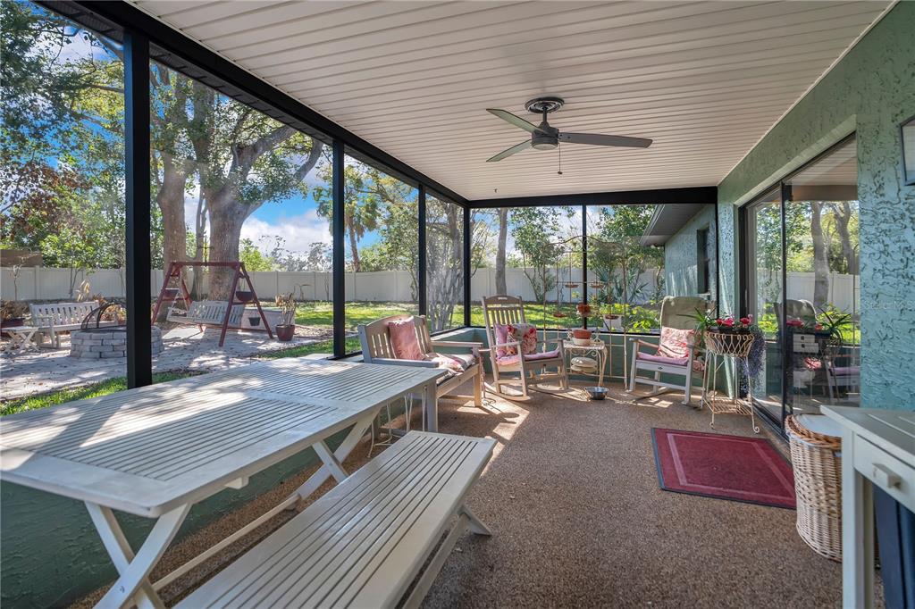8431 Delaware Drive Weeki Wachee, FL 34607 - Photo 39 of 64 a view of a patio with a table chairs and a backyard