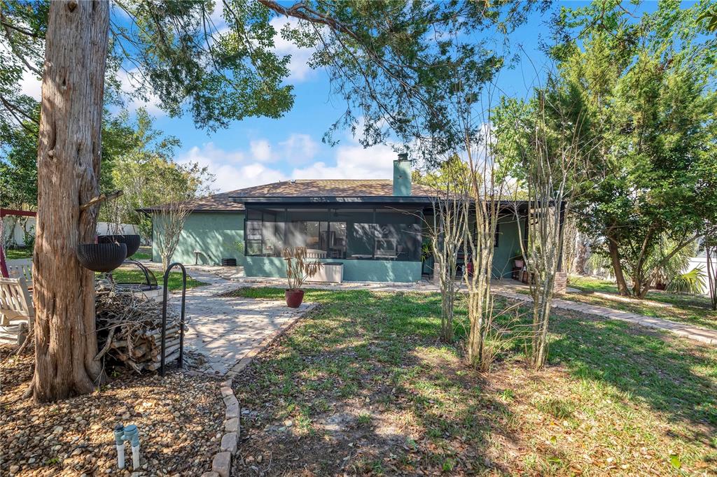 8431 Delaware Drive Weeki Wachee, FL 34607 - Photo 47 of 64 a view of a house with backyard porch and sitting area