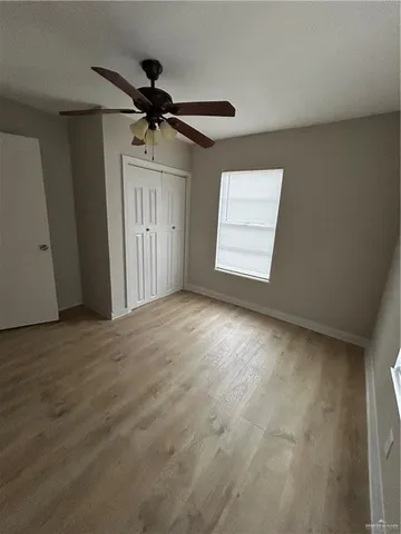a view of a livingroom with a ceiling fan and window