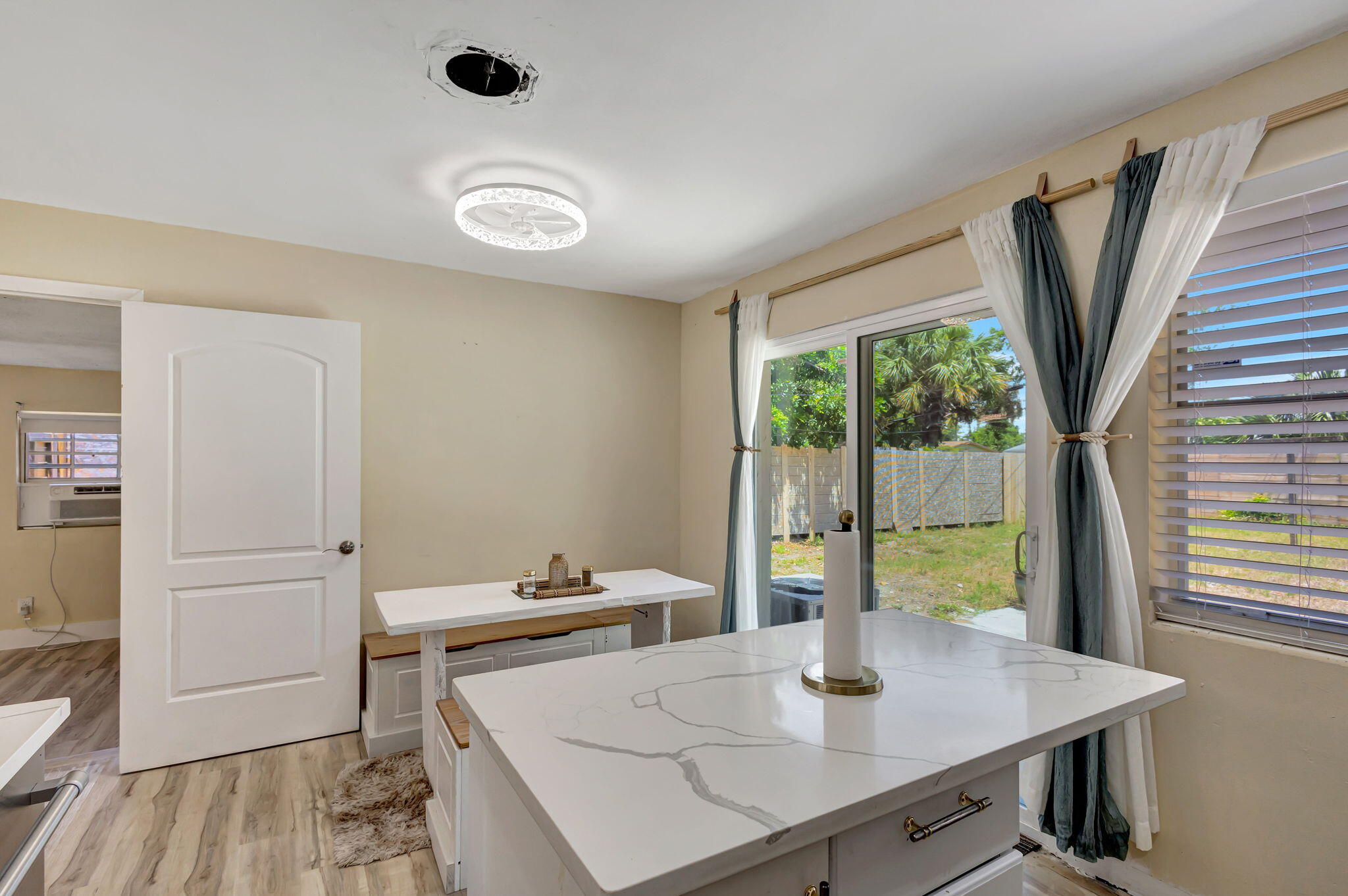 140 West 31st Court Riviera Beach, FL 33404 - Photo 11 of 43 a view of a dining room with furniture and a window