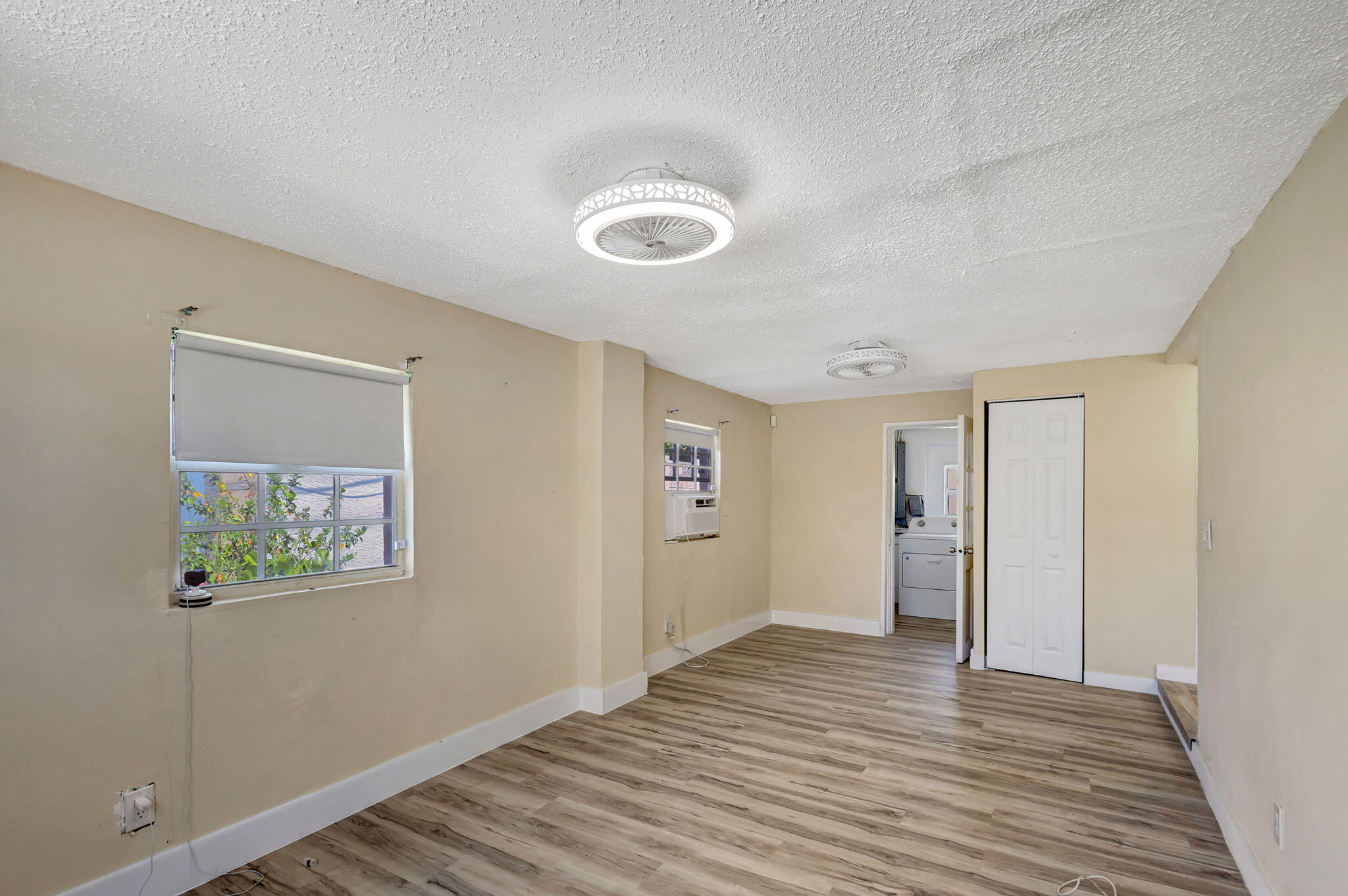 140 West 31st Court Riviera Beach, FL 33404 - Photo 17 of 43 a view of a room with wooden floor and hallway