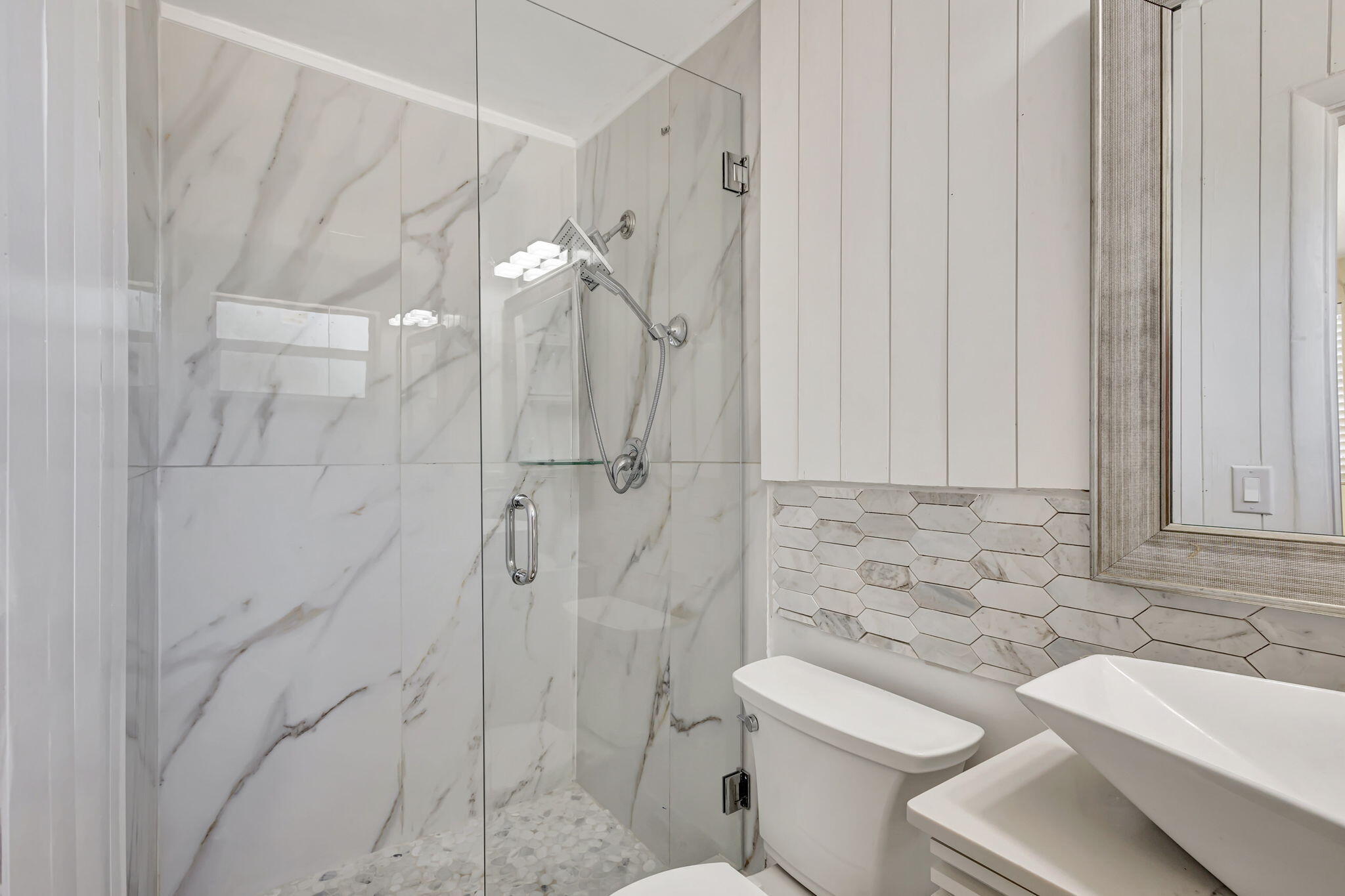 140 West 31st Court Riviera Beach, FL 33404 - Photo 20 of 43 a bathroom with a sink a toilet and shower