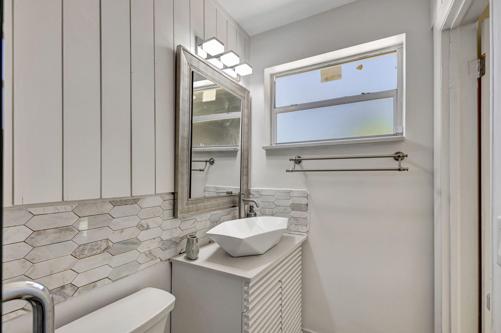 140 West 31st Court Riviera Beach, FL 33404 - Photo 22 of 43 a bathroom with a sink and a mirror