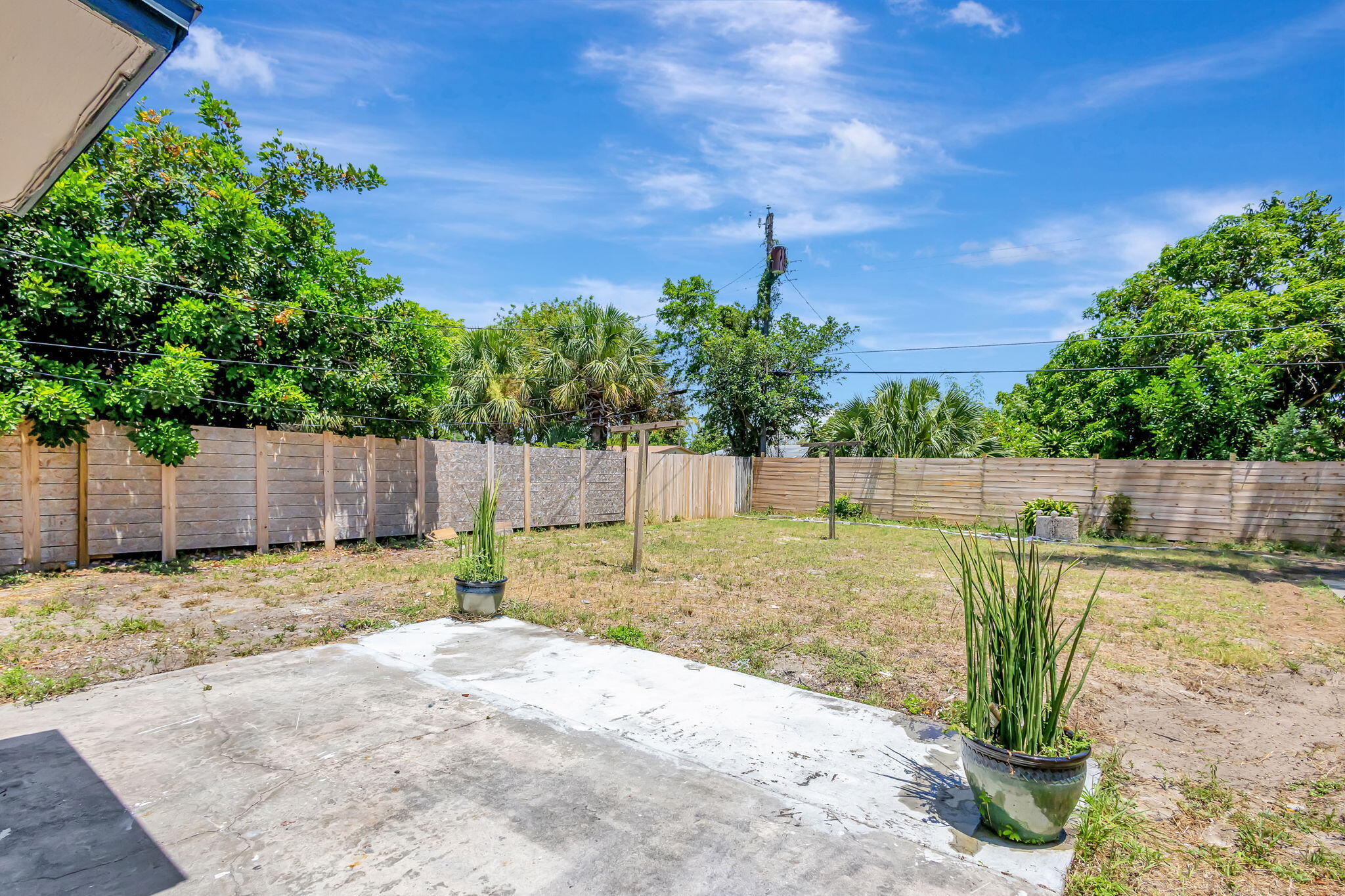 140 West 31st Court Riviera Beach, FL 33404 - Photo 23 of 43 a view of a backyard with wooden fence