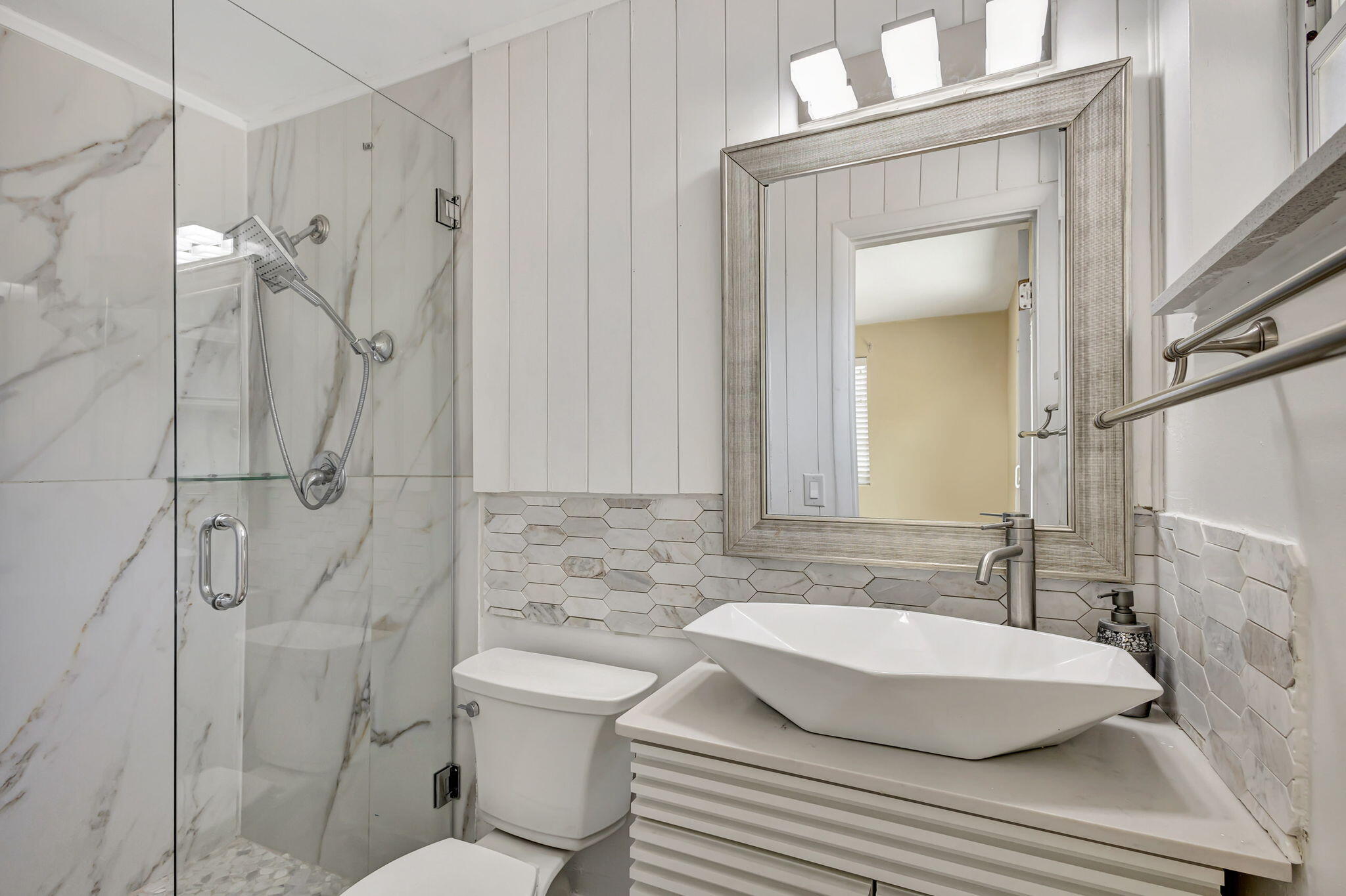 140 West 31st Court Riviera Beach, FL 33404 - Photo 31 of 43 a bathroom with a sink toilet and shower