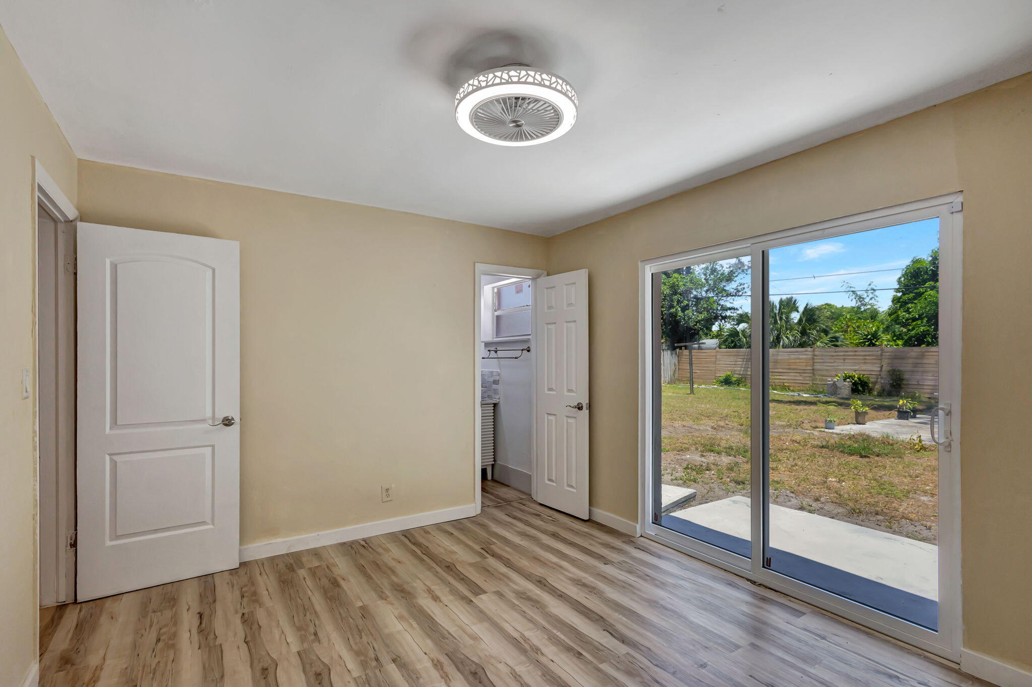 140 West 31st Court Riviera Beach, FL 33404 - Photo 34 of 43 a view of empty room with wooden floor and fan
