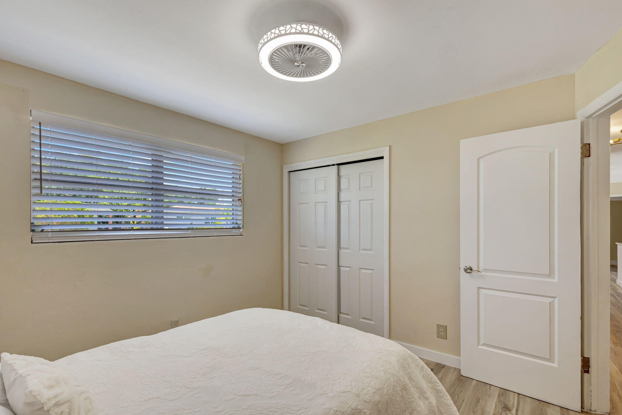 140 West 31st Court Riviera Beach, FL 33404 - Photo 35 of 43 a bedroom with a bed and a window