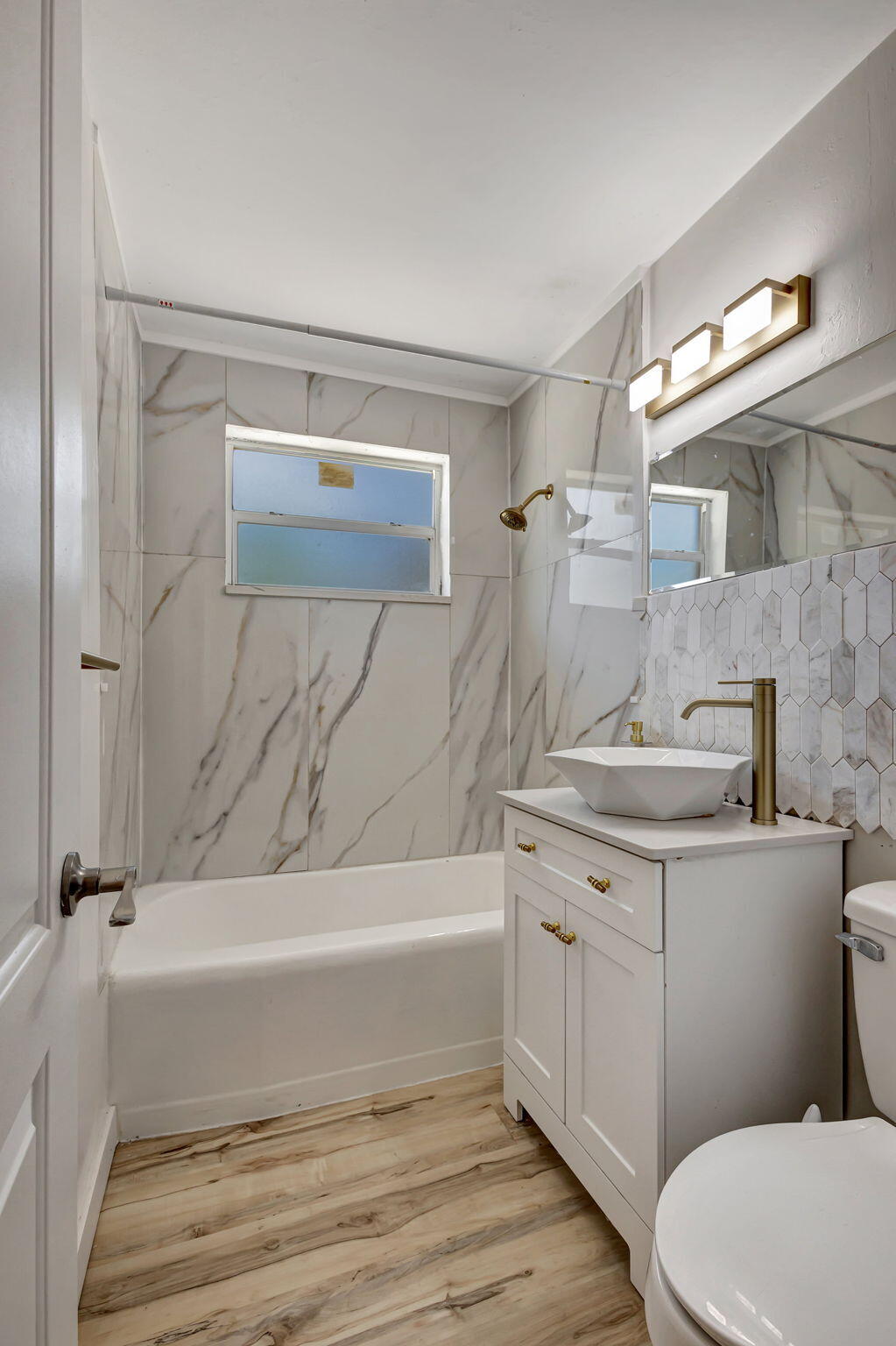 140 West 31st Court Riviera Beach, FL 33404 - Photo 37 of 43 a bathroom with a sink a toilet and shower