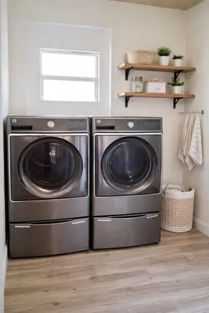 a utility room with sink dryer and washer