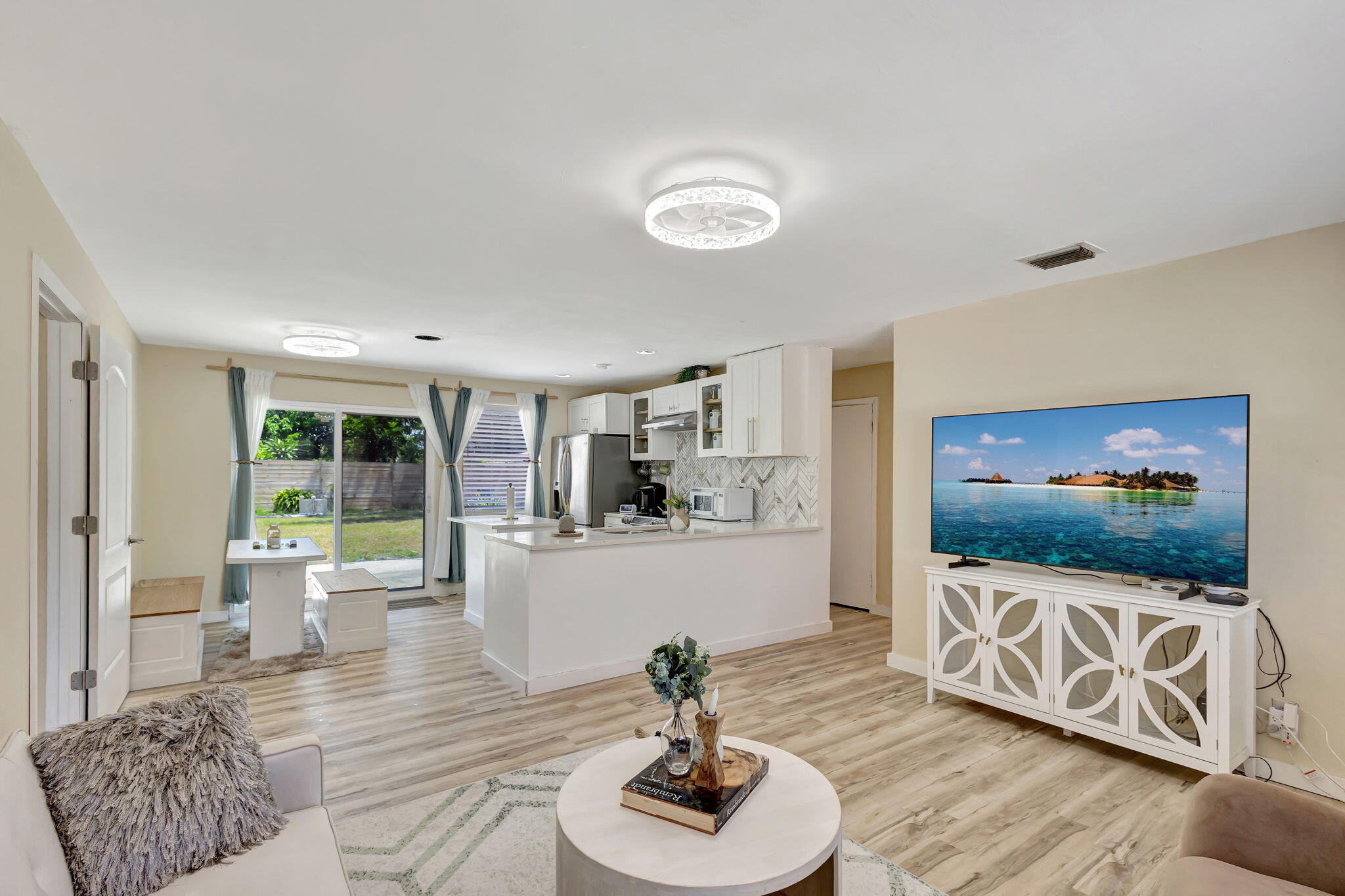 140 West 31st Court Riviera Beach, FL 33404 - Photo 6 of 43 a living room with furniture and a flat screen tv