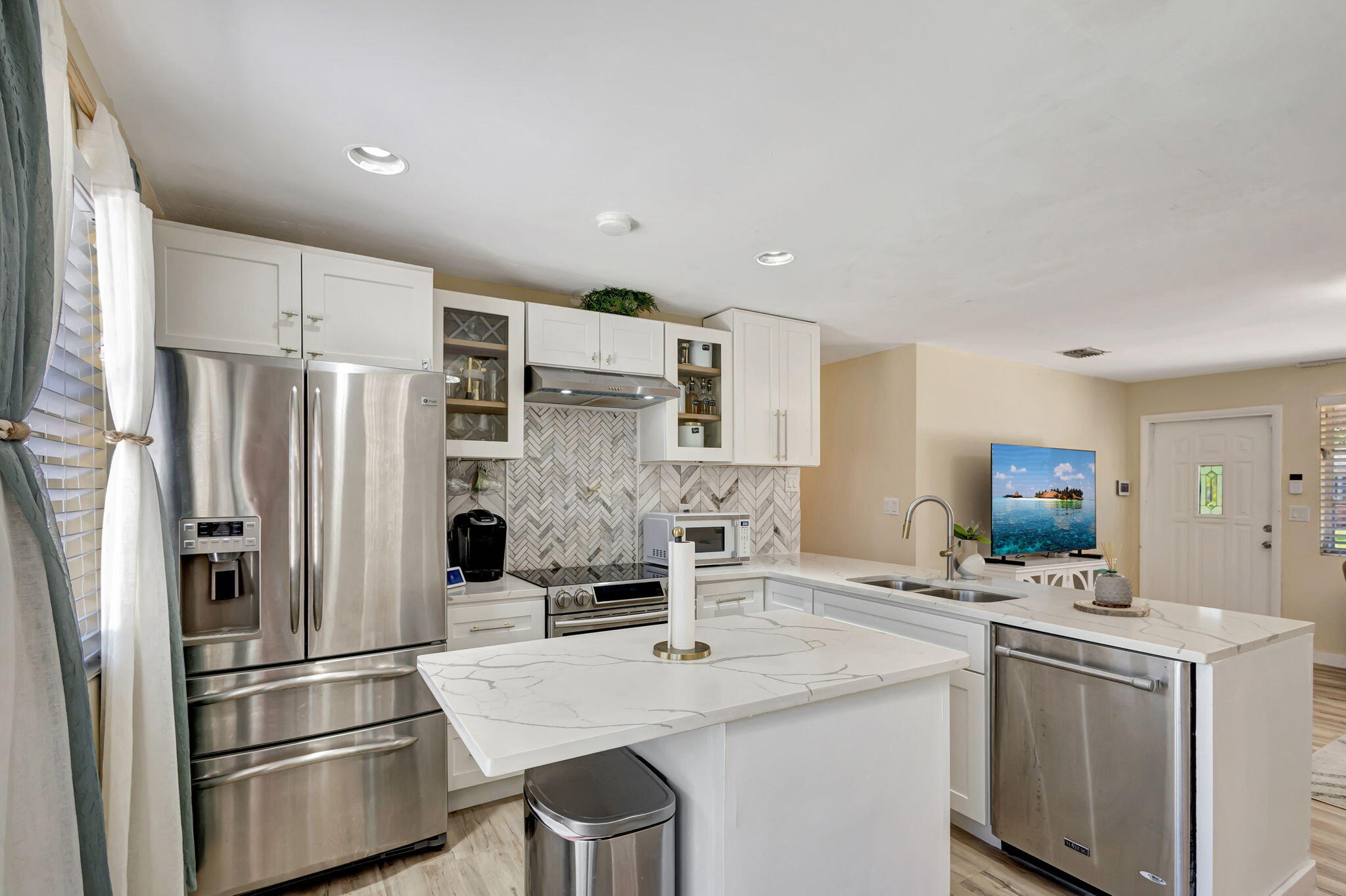140 West 31st Court Riviera Beach, FL 33404 - Photo 8 of 43 a kitchen with stainless steel appliances a refrigerator sink and stove
