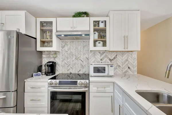 a kitchen with cabinets a sink and a refrigerator