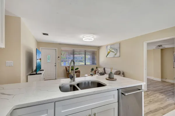 a kitchen with a sink and a mirror