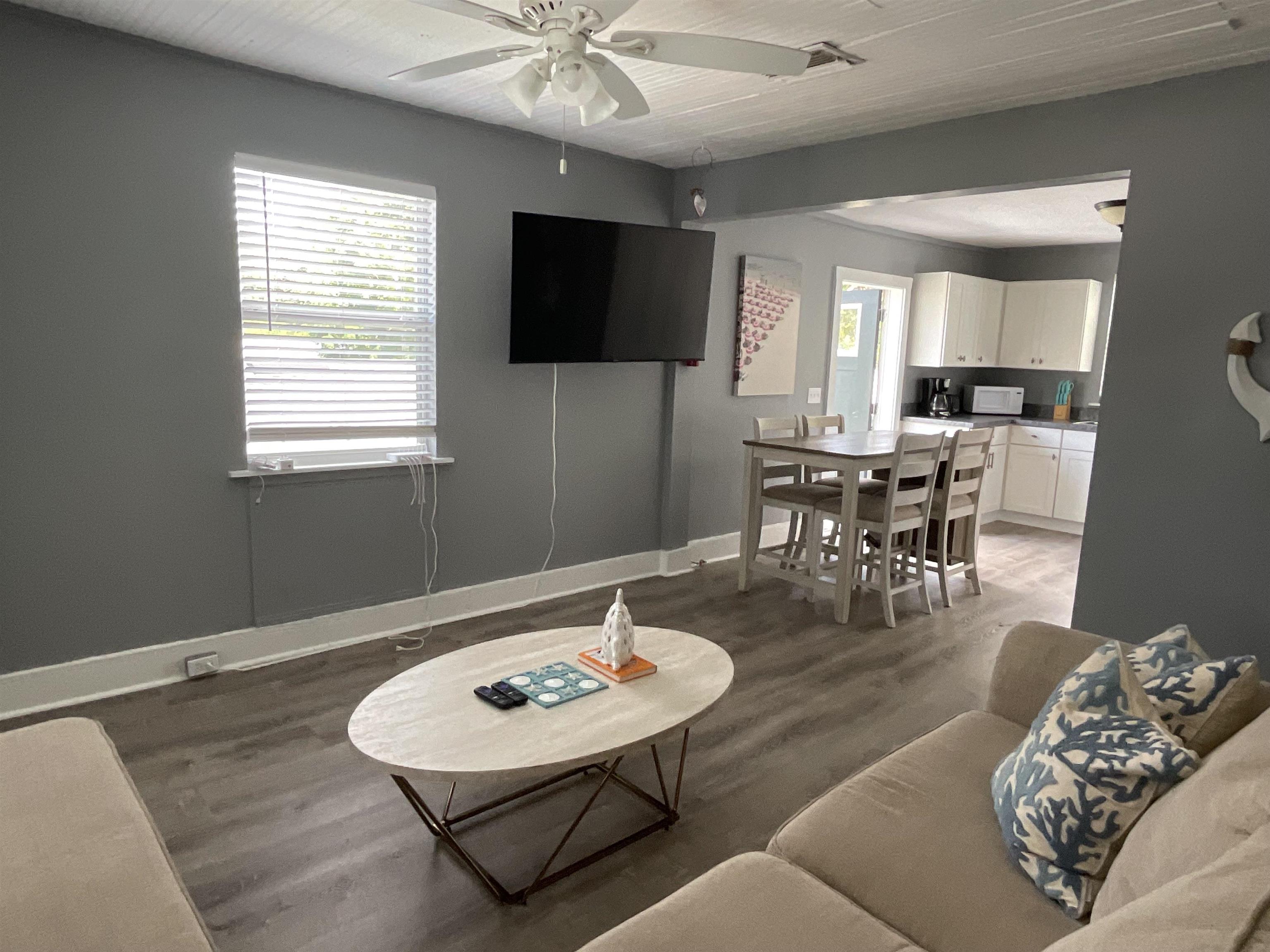 93 Keith Street, Unit B St. Augustine, FL 32084 - Photo 11 of 14 a living room with furniture and a flat screen tv