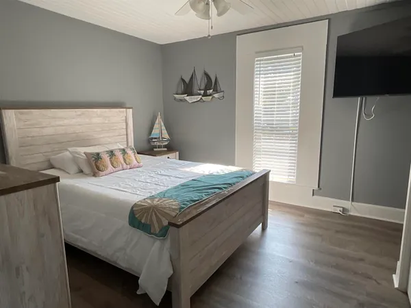 a bedroom with a bed and a flat screen tv