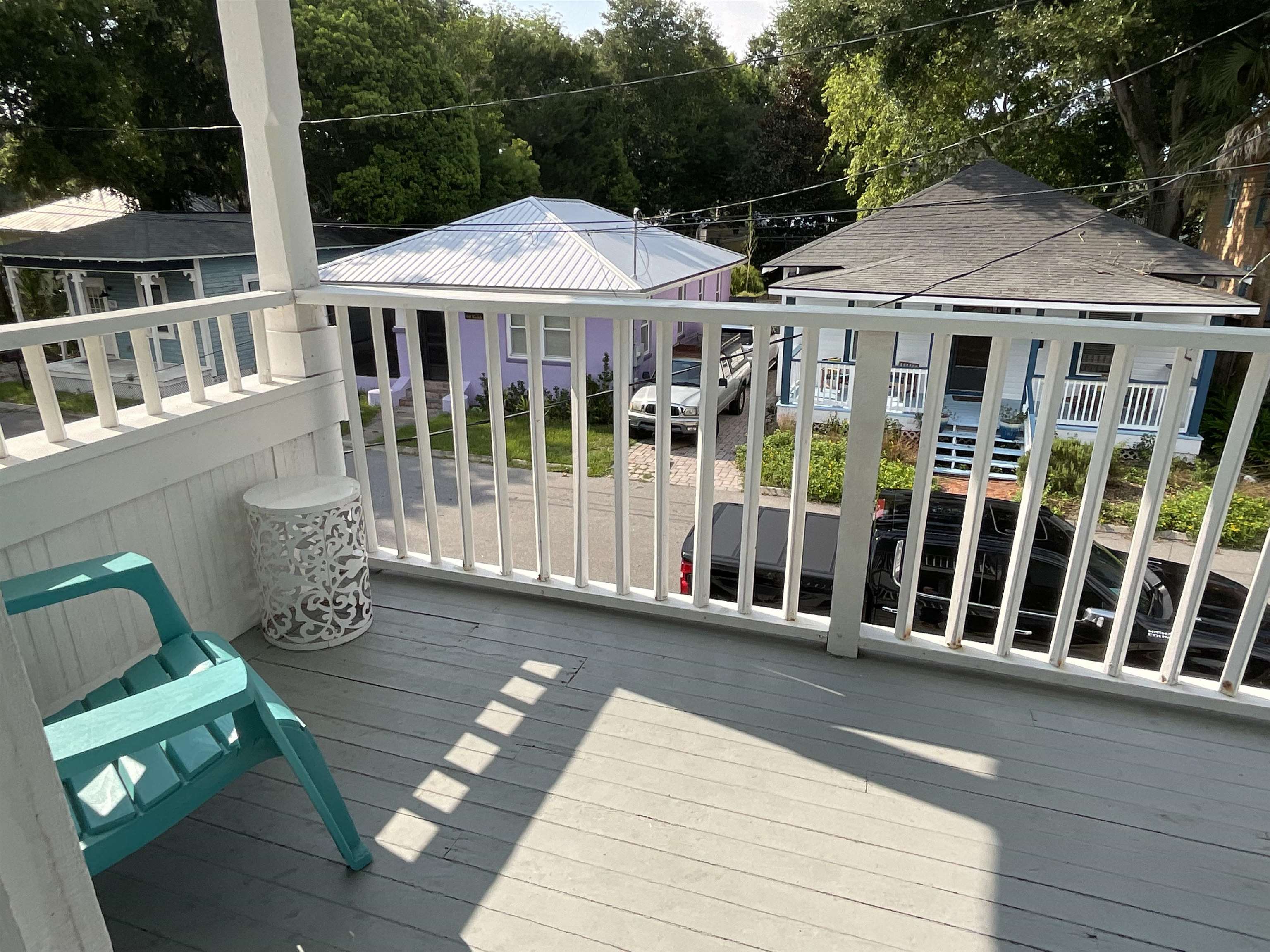 93 Keith Street, Unit B St. Augustine, FL 32084 - Photo 7 of 14 a view of a house with wooden deck and furniture