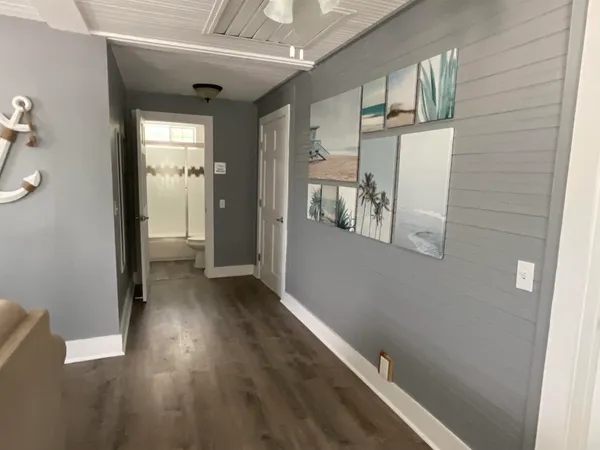 a view of a hallway with wooden floor and staircase