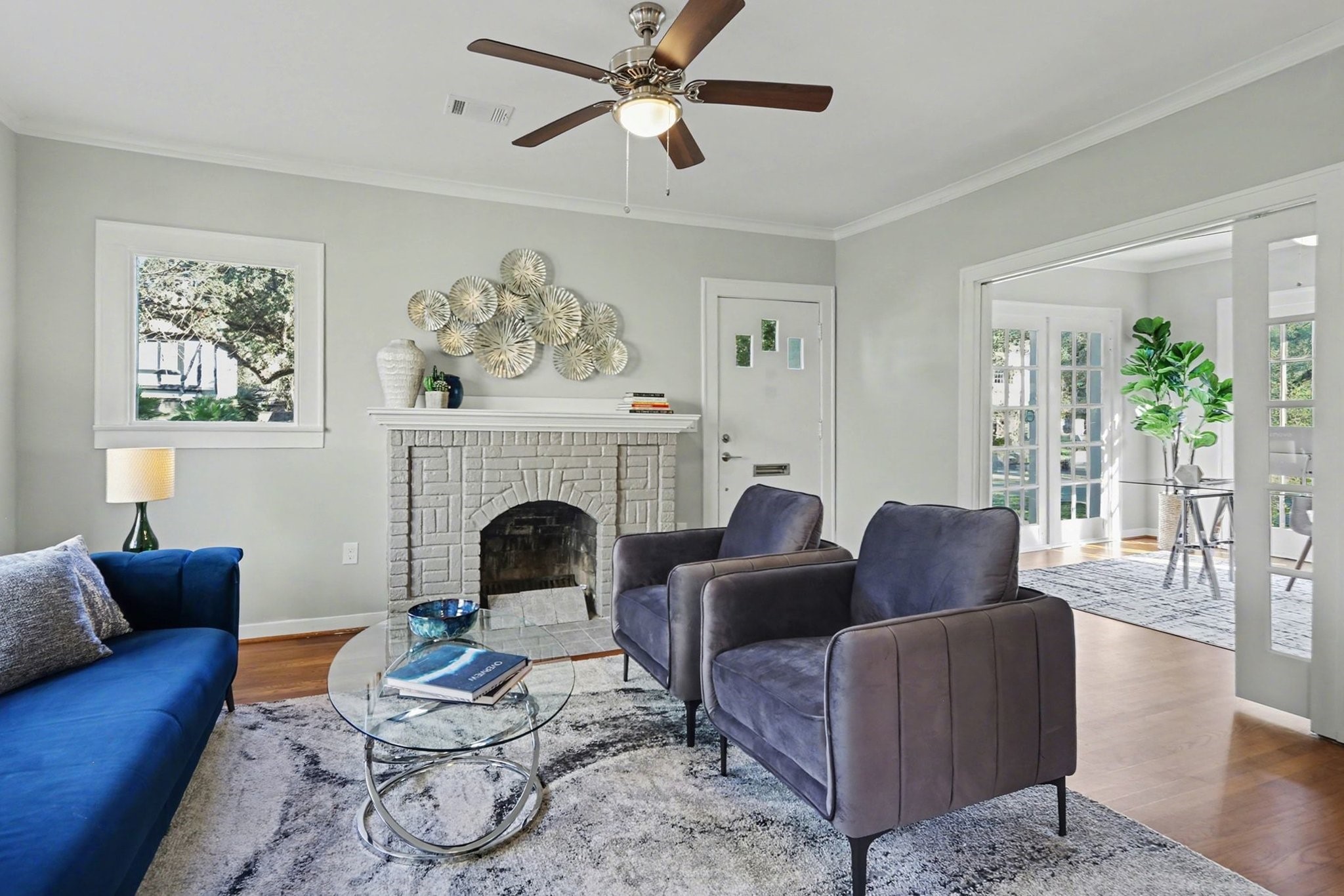 1901 Lexington Street Houston, TX 77098 - Photo 3 of 32 a living room with furniture a fireplace and a ceiling fan