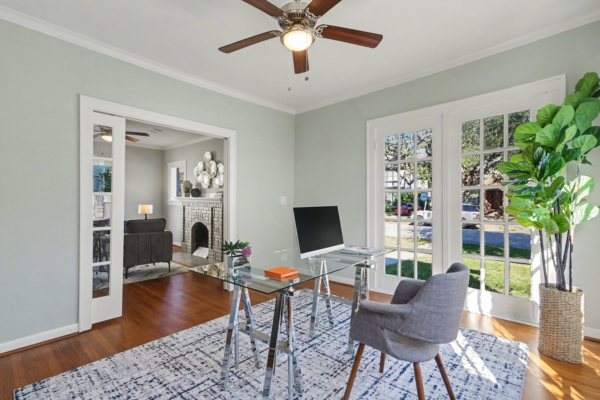 1901 Lexington Street Houston, TX 77098 - Photo 7 of 32 a workspace with wooden floor and a chandelier fan