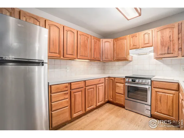 a kitchen with stainless steel appliances granite countertop a refrigerator sink and cabinets