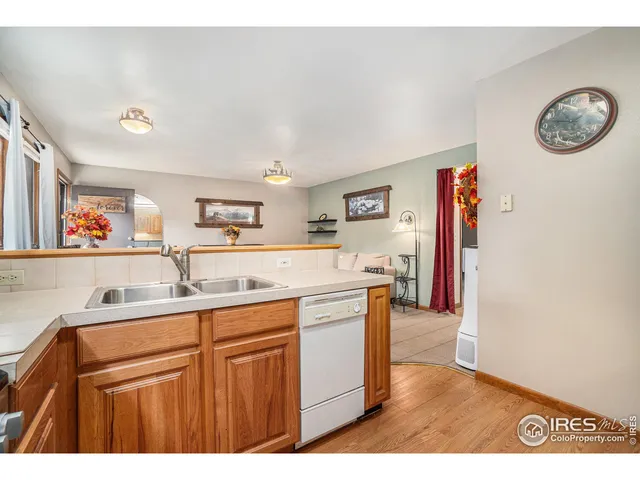 a kitchen with a sink cabinets and wooden floor