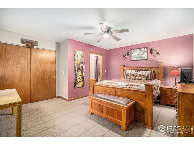 a spacious bedroom with a bed and a chandelier