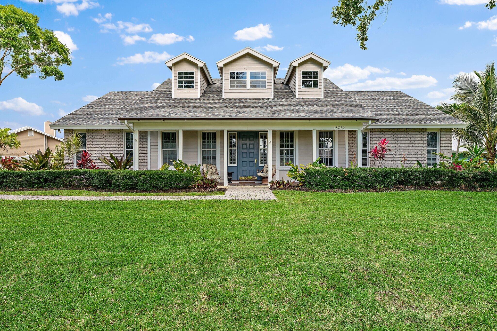 a front view of a house with garden