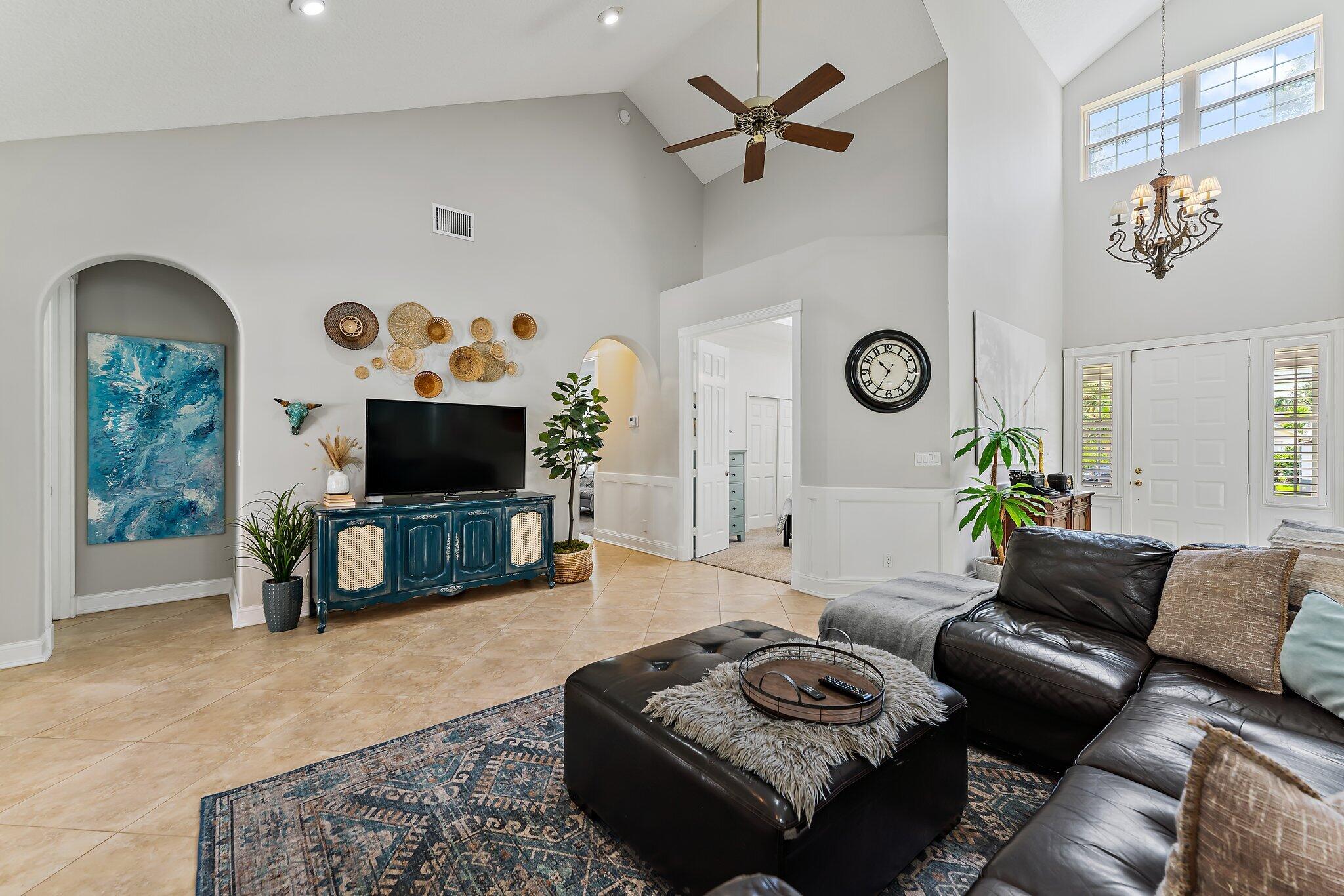 18263 River Oaks Drive Jupiter, FL 33458 - Photo 16 of 49 a living room with furniture a flat screen tv and a window